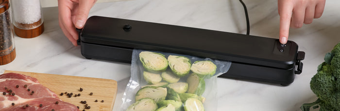 A person vacuum sealing food