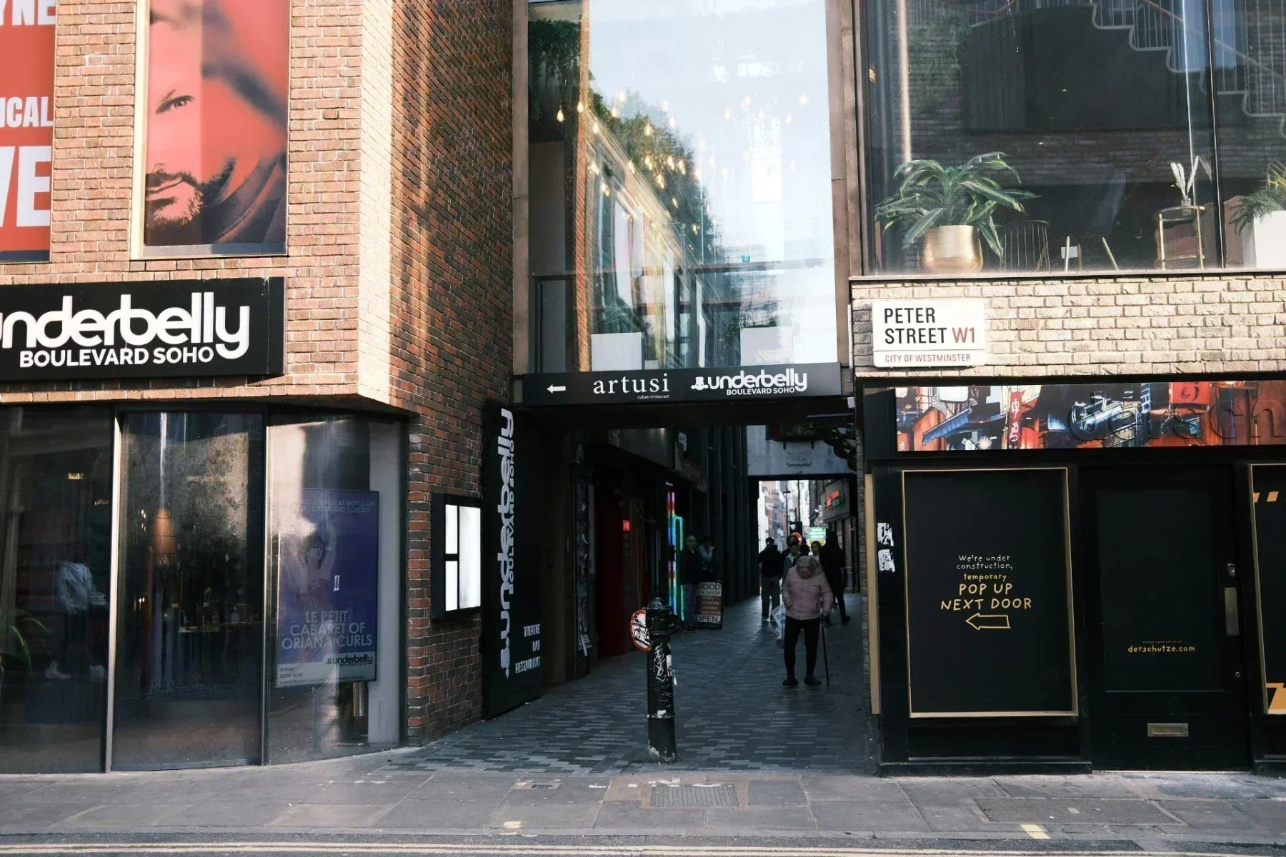 Underbelly Boulevard Soho pop-up restaurant entrance on Peter Street, London, with pedestrians