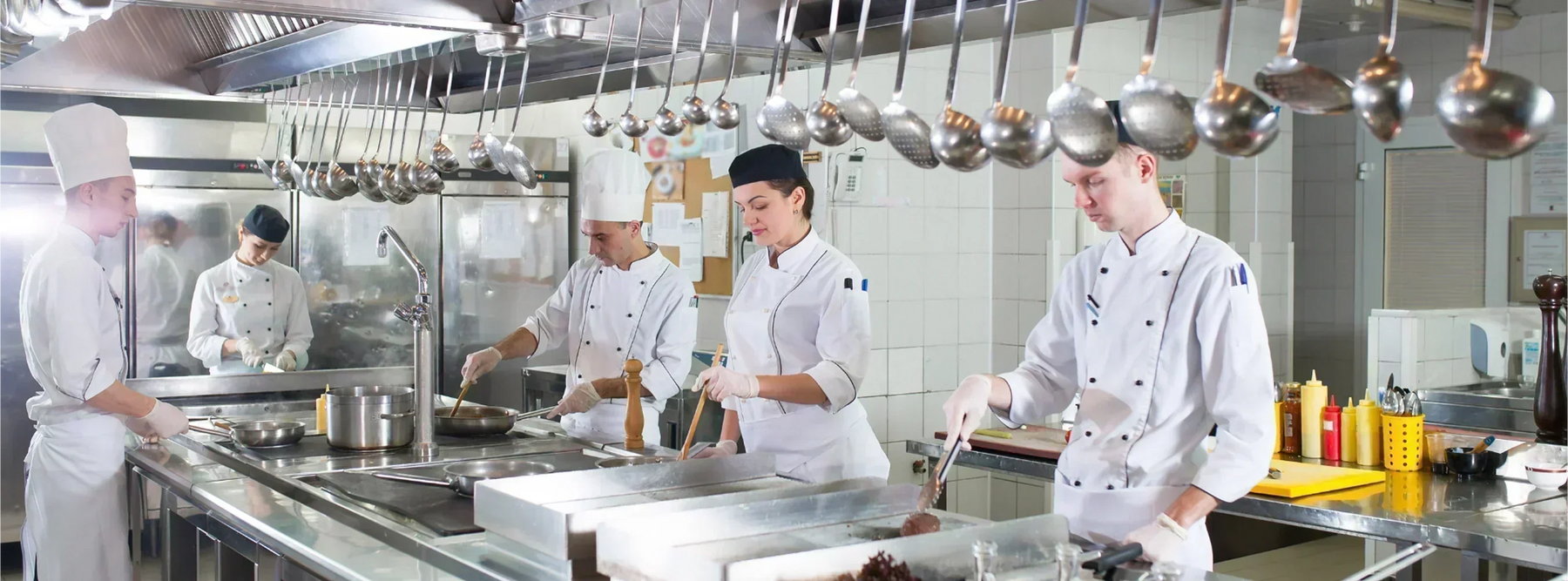 Restaurant chefs cooking in a commercial kitchen