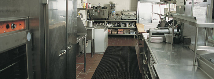 a commercial kitchen pass with floor mats