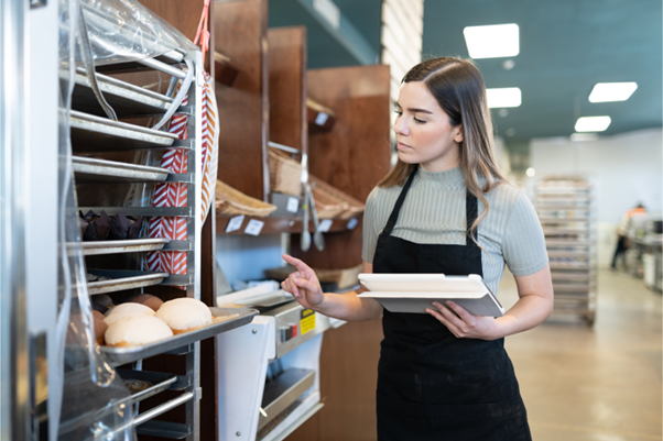 A bakery owner completing an inventory of her baked goods