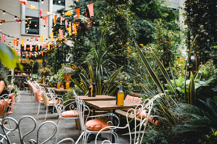 A vibrant restaurant patio surrounded by lush vegetation
