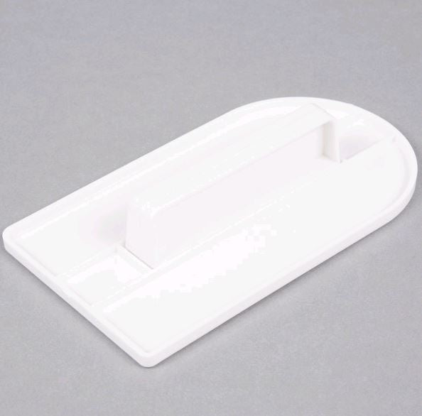 White plastic fondant smoother against grey background