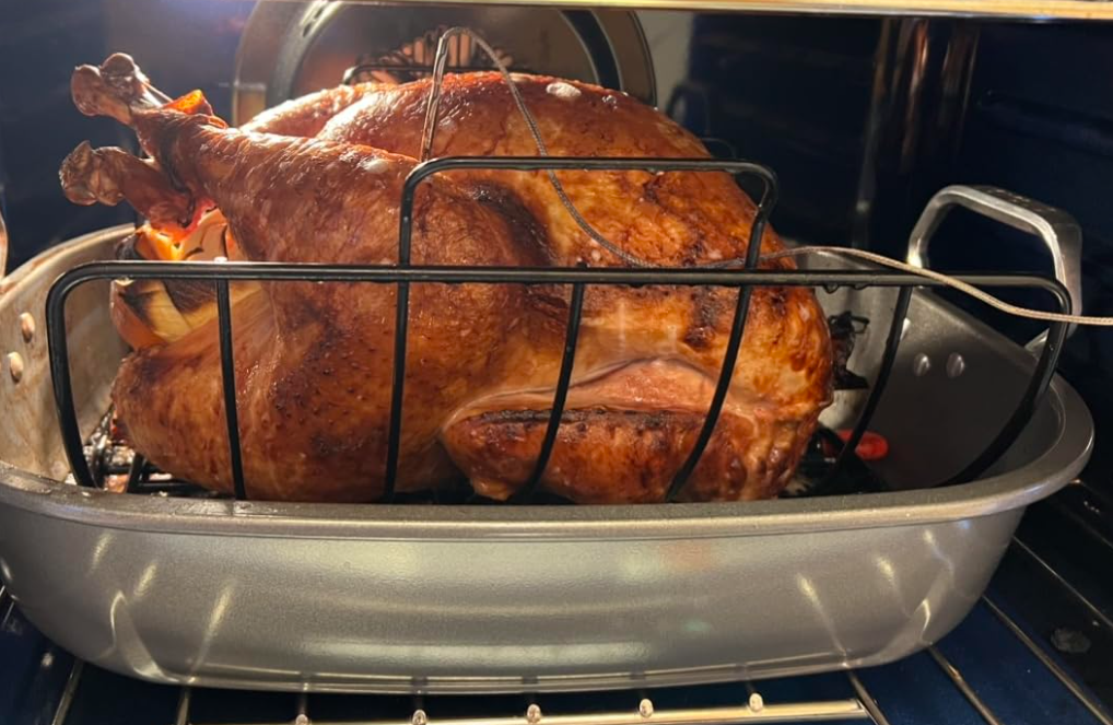 Browne® 746780 Collapsible Roast Rack holding a turkey on white background