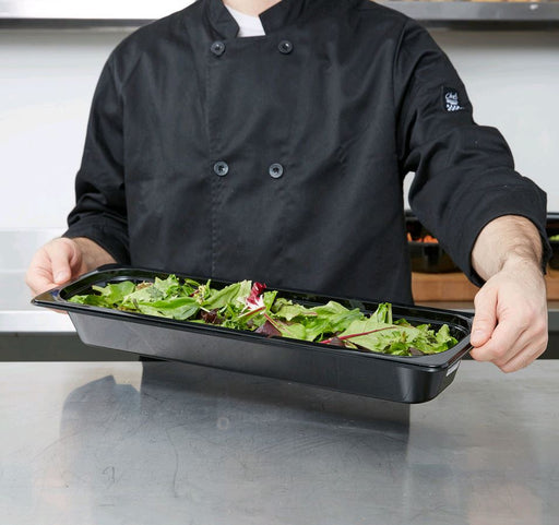 Cambro Camwear 1/2 Size Long Black Polycarbonate Food Pan 22LPCW110 full being held by chef