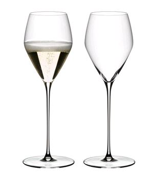 RIEDEL 6330/28 Veloce Champagne Wine Glass - 2 Pack on white background with one full of champagne